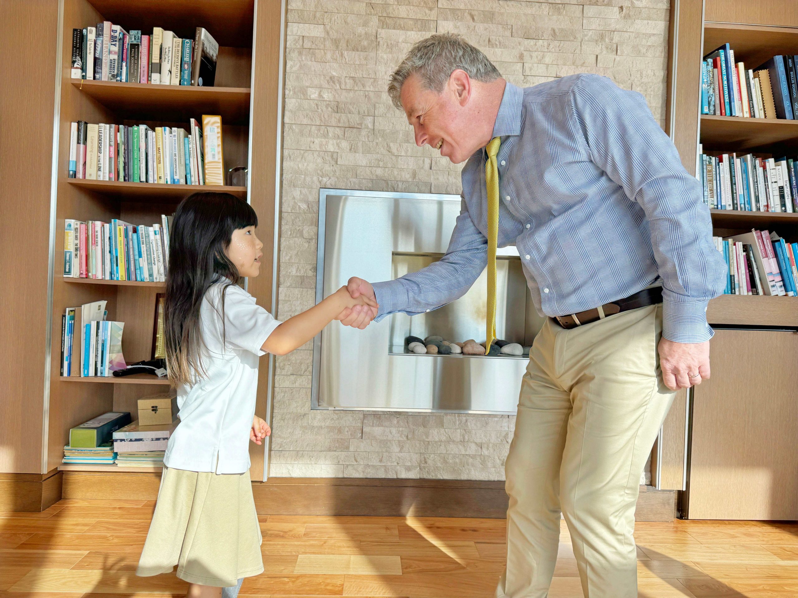 Christian Sullivan shaking hands with student